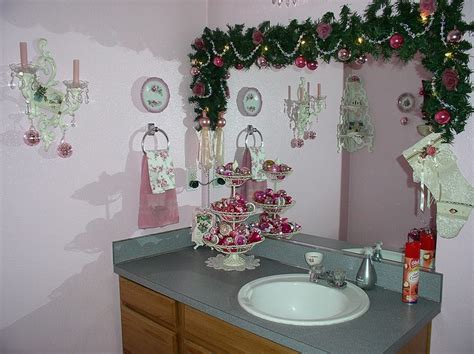 The dining room is kept simple with mini cypress trees, while the living room has hits of greenery and candles that glow with warmth. Pink Christmas decor in bathroom | Christmas bathroom ...