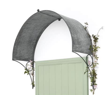 An Arch Over A Green Door With Flowers Growing On The Top And Bottom