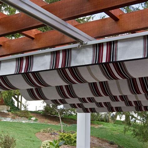 A custom canopy and draperies made from sunbrella outdoor fabric help keep the elements (and the sun) out while also softening the space. Pergola Shade Canopy | Country Lane Gazebos