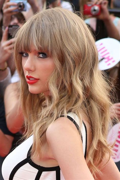 Taylor Swift Wavy Ash Blonde Choppy Layers Straight Bangs Hairstyle