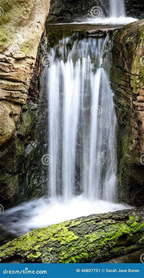 Beautiful Long Exposure Of Waterfall In Mossy Sandstone Canyon Stock