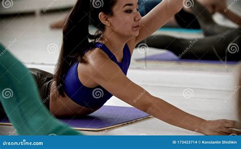 Young Women Training Lying On The Yoga Mat In The Studio Lying On The