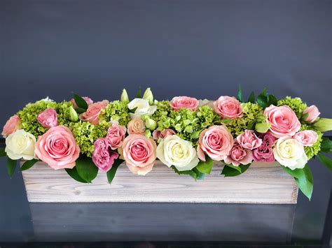 long wood box arrangement for a table with white and pink roses lisianthuses and hydrangeas