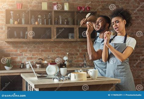 black couple dancing and singing while baking in kitchen stock image image of house home