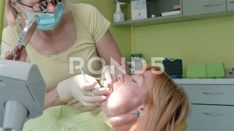 Close Up View Of Woman Dentist Working At Her Patients Teeth In Dentist