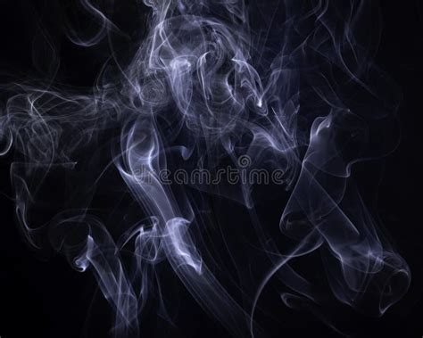 A Close Up Macro Photo Of Incense Smoke Lit By A Blue Flash To Create A