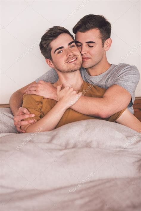Gay Couple Lying Together In Bed Stock Photo By Mavoimages