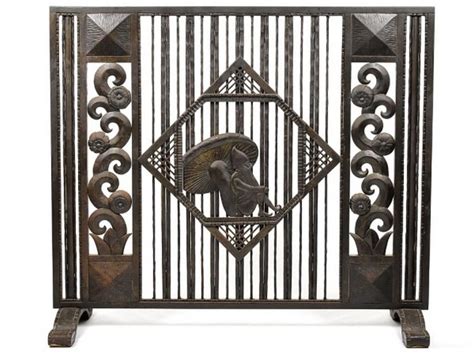 Art deco cabinet in living room with old leather suitcases. Wrought iron Art Deco fire screen, French c. 1925. Height ...