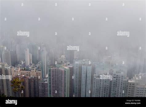 The Skyline Of The City Is Covered In Low Clouds And Sea Fog During