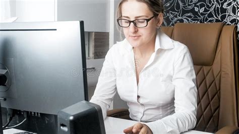 Portrait Of Elegant Female Secretary Working In Office On Computer