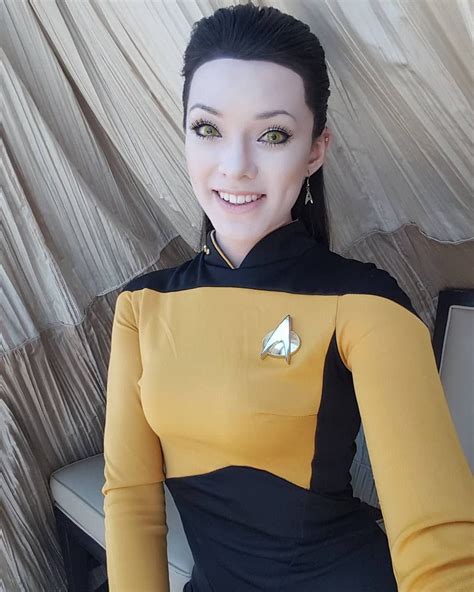 A Woman In A Star Trek Costume Sitting On A Chair