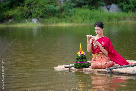 Beautiful Thai Girl Wearing Red Thai Traditional Dress Praying On River Raft In Loy Krathong