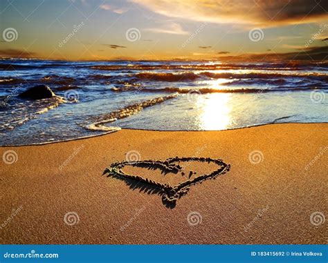 Heart Symbol On Sunset Beach Sand And Sea Water Reflection Light Nature