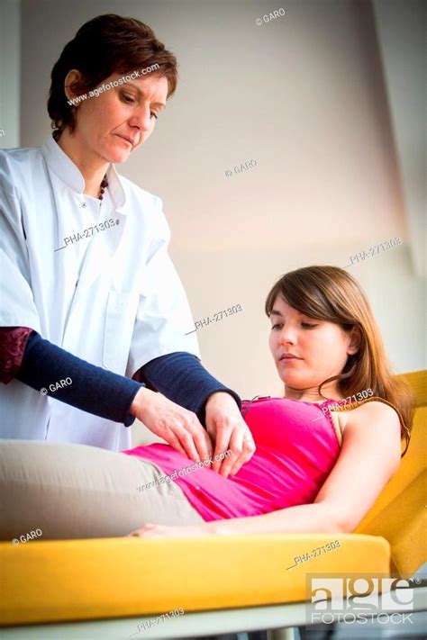 Doctor Examining The Abdomen Of A Female Patient By Palpation Stock