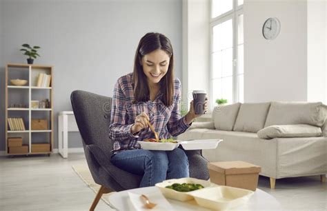 Happy Woman Drinking Coffee And Eating Vegetable Salad From Takeout Meal Delivery Stock Image