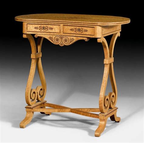 Sn3880, an attractive continental, kidney shaped occasional table in satinwood, having segmented top and inlaid frieze with practical drawer flanked by ormolu raise on slender cabrio. KIDNEY-SHAPED TABLE,