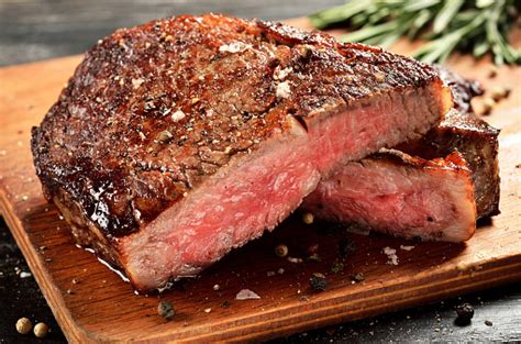 Medium Rare Ribeye Steak On Wooden Board Selected Focus Stock Photo