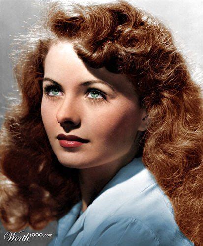 An Old Photo Of A Woman With Long Red Hair And Blue Shirt Looking To