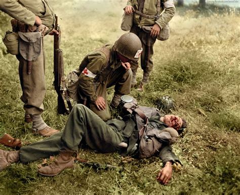 An American Medic Tends To A Seriously Injured German Soldier Who