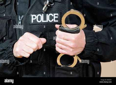 Police Officer Holding Handcuffs Stock Photo Alamy