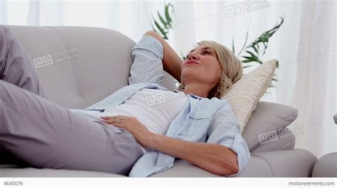 Woman Smiling And Relaxing On Sofa Stock Video Footage 4640076