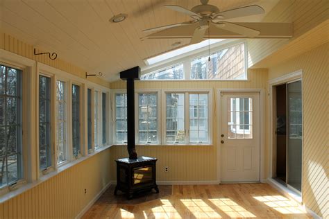 This is an example of a traditional porch design in milwaukee with a roof extension. beautiful sunroom with a working wood burning stove that ...