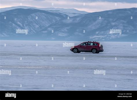 Travel By Car On The Ice Road Of The Frozen Lake Baikal In Siberia