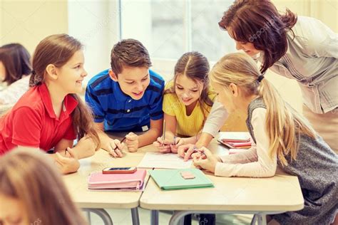 Group Of School Kids Writing Test In Classroom Stock Photo By ©syda