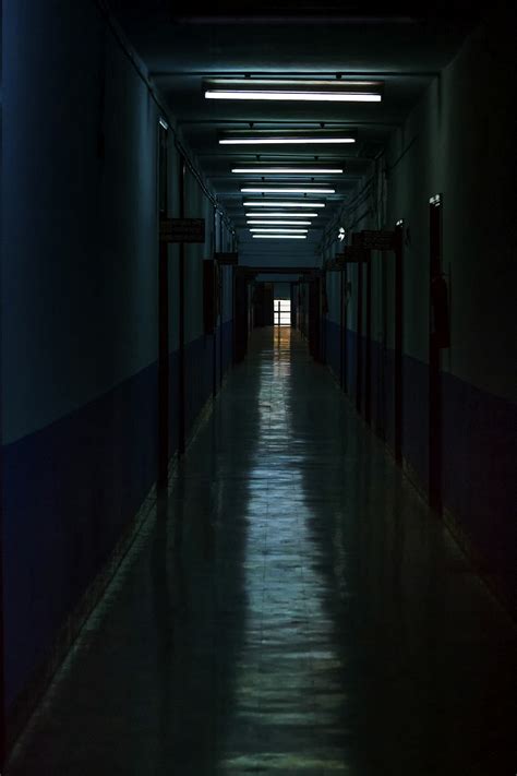 Empty Hallway With Light Turned On In The Middle Photo Free Corridor