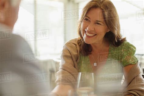 Smiling Mature Woman Enjoying Date Dining At Restaurant Stock Photo