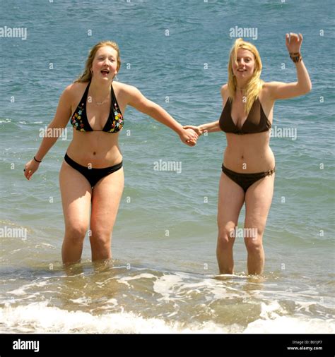 Two Young Women Frolicking In The Mediterranean Sea Fuengirola Beach