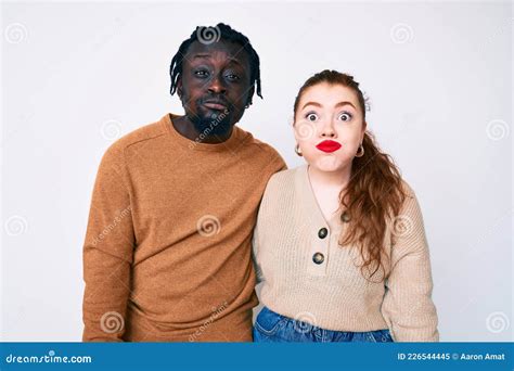 Interracial Couple Wearing Casual Clothes Puffing Cheeks With Funny Face Stock Image Image Of