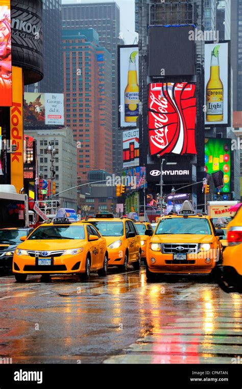 Iconic New York Yellow Taxis In Times Square Manhattan Reflections From The Rain And Puddles