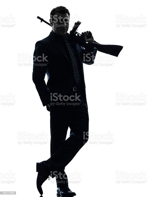 Gangster Man Holding Thompson Machine Gun Silhouette Stock Photo