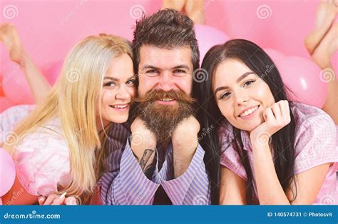 Girls Fall In Love With Bearded Macho Pink Background Threesome On Smiling Faces Lay Near