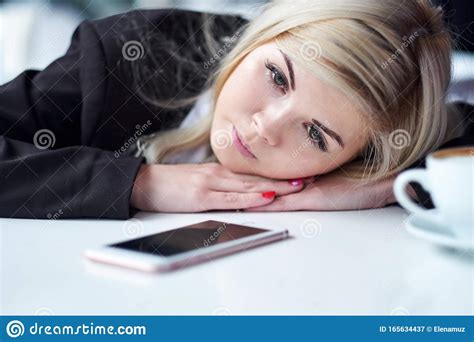 Disappointed Sad Woman Looking At Phone And Waiting Message Or Call