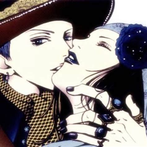 A Man And Woman Kissing Each Other While Wearing Hats
