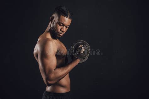 Side View Of Muscular Shirtless African American Man Exercising With