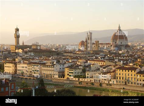 florence city during golden sunset panoramic view of the river arno with palazzo vecchio palace