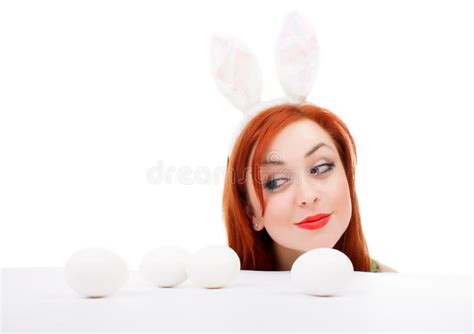 Easter Bunny Female Looking Over Table For Easter Eggs Stock Photo