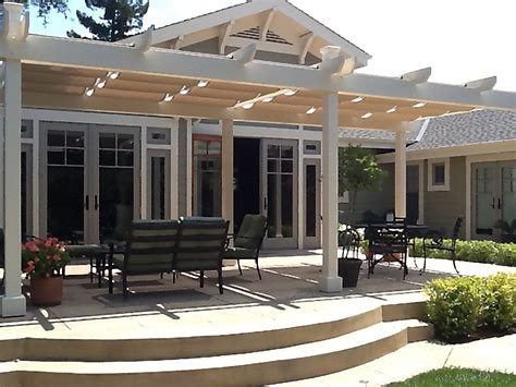 Retractable shade canopies & motorized retractable screen added by the customer. Absolutely Custom Canopy and Patio Shade Structures