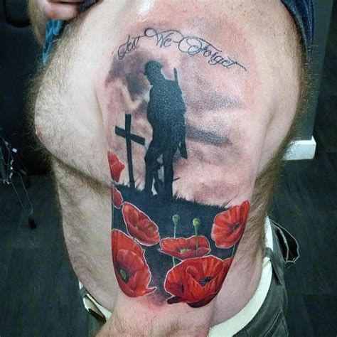 Solider Mourning Cross Grave With Poppy Flowers Tattoo On Upper Arm Of