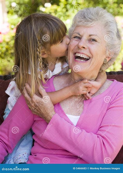 Grandmother Getting A Kiss From Granddaughter Stock Image Image Of