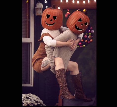 two people in pumpkin costumes hugging each other