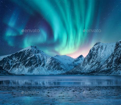 Northern Lights Above Snow Covered Rocks Winter Landscape Stock Photo