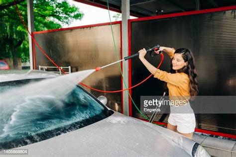 Young Woman Getting Wet At Car Wash Smiling Photos And Premium High Res