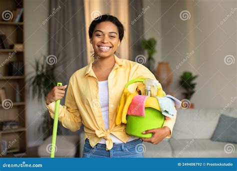 Happy Black Woman Holding Mop And Detergent Bottles Cleaning Home Stock