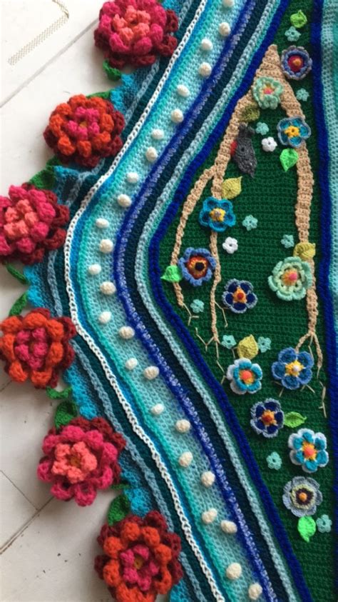 A Crocheted Table Cloth With Flowers And Beads On The Edges Sitting On