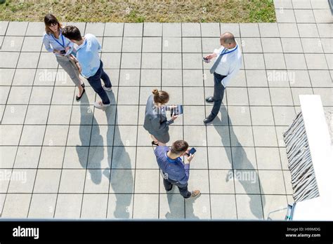 Group Of Business People Using Smartphones And Digital Tablets Outdoors