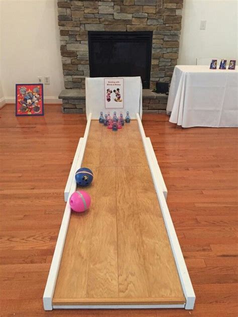 A Bowling Game Is Set Up On The Floor In Front Of A Fire Place And